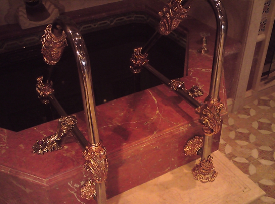 Decorative finishing  of the swimming pool stairs. Material:  stainless steal, bronze, gilt, semi-precious stones.